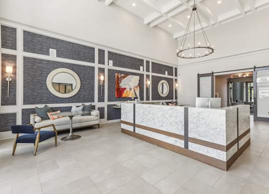 a lobby with a reception desk and a couch