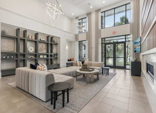 a living room with couches and tables and a fireplace