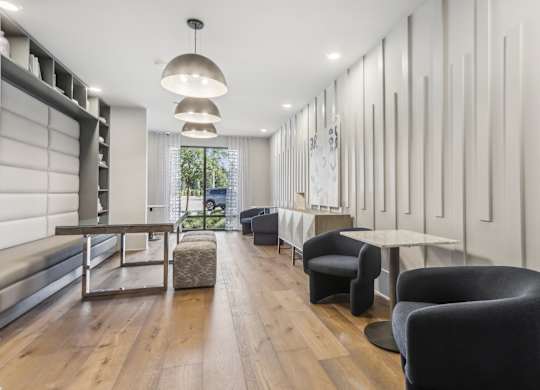 a living room with chairs and tables and a fireplace