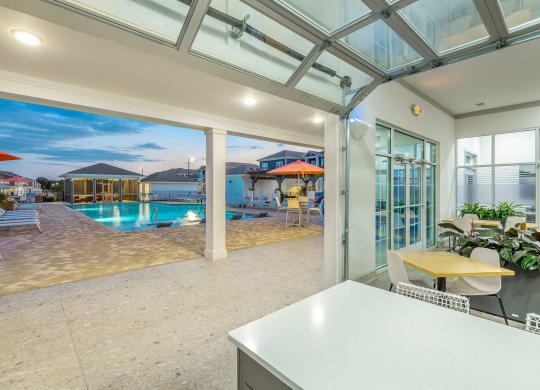 garage door open air indoor/outdoor social lounge and pool at Anthem Apartments and Cottages in Huntsville, Alabama