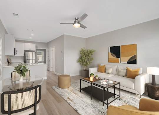 A modern living room with a glass table and a white sofa.