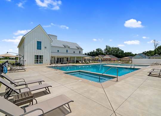A large white building with a pool in front.