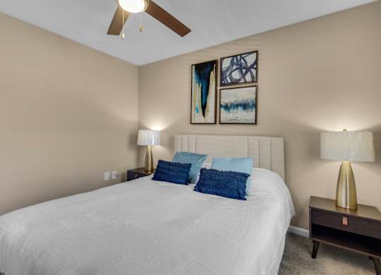 A bedroom with carpet flooring and ceiling fan at Crystal Lake in Pensacola, Florida.