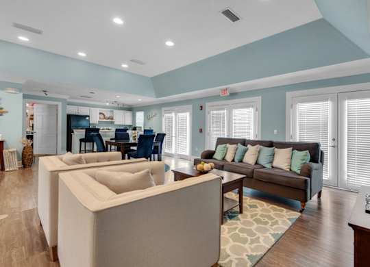 Clubhouse with an open floorplan including lounge areas and a community kitchen at Crystal Lake in Pensacola, Florida.