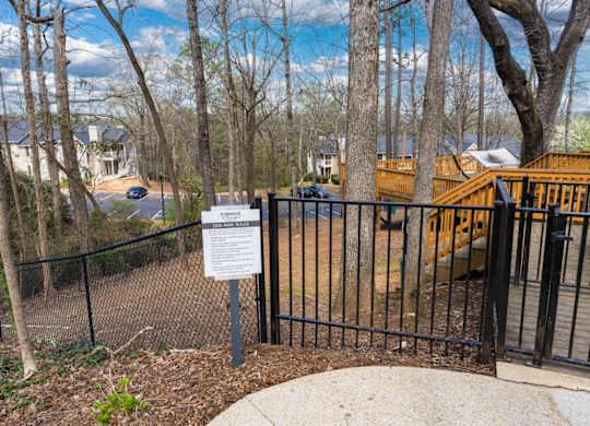 Dog park overlooking apartment buildings and woods at Summerchase at Riverchase in Hoover, Alabama