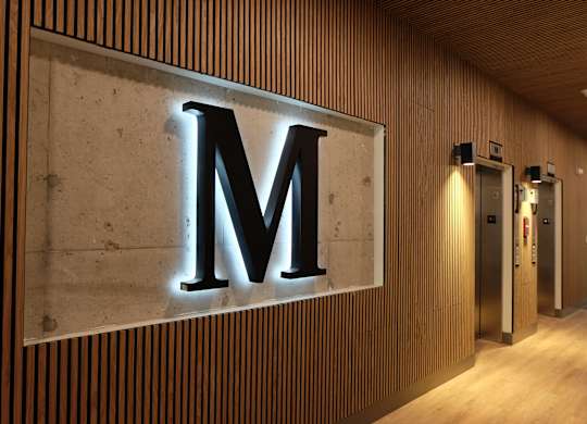 a large metal letter m on the side of a building