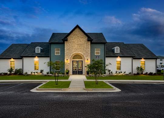 a house with a dark blue sky in the background