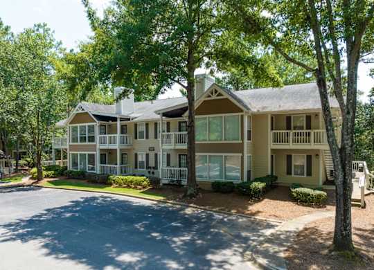 Exterior view of apartment building, trees and landscaping at Summerchase at Riverchase in Hoover, Alabama