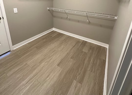 Empty walk-in closet with shelves and wood flooring at The Fitzroy Apartments in Birmingham, AL
