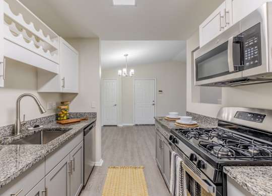 A kitchen with granite countertops and stainless steel appliances  at Grande View Apartments in Biloxi, M