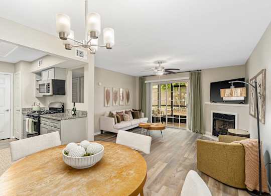 A modern living room with a fireplace and a dining table.