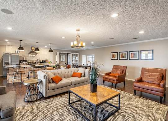 A living room with a brown leather couch and a wooden coffee table.