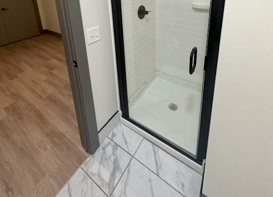 a walk in shower in a 555 waverly unit