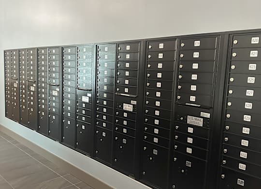 a row of metal lockers with white labels