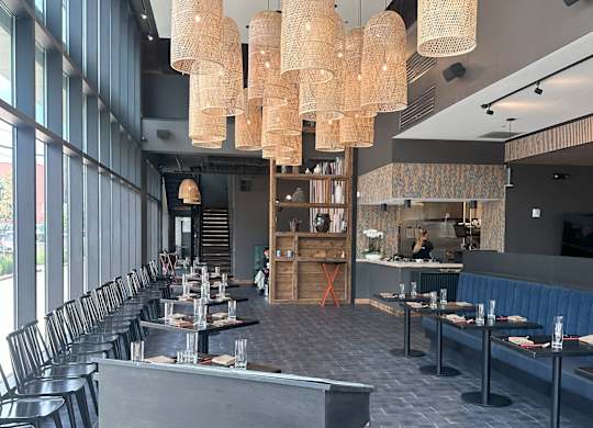 a restaurant with a long dining room with many tables and chairs