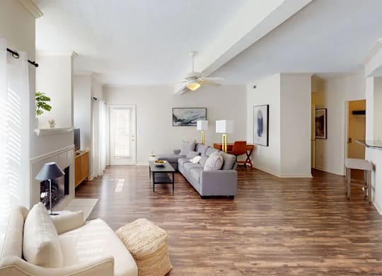 A living room with a white couch and a television.