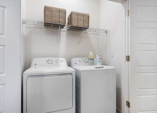 A white washing machine and dryer in a small laundry room.