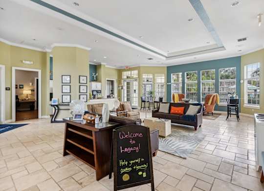 a large living room with a chalkboard sign in the middle