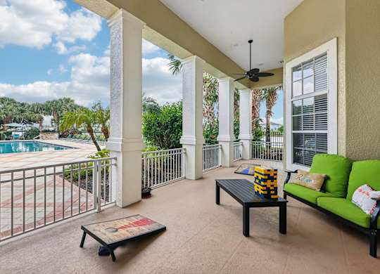 a balcony with a pool and a couch and a coffee table