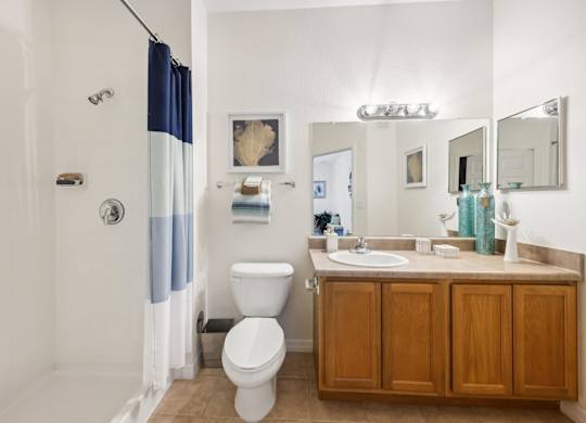 a bathroom with a toilet and a sink and a shower