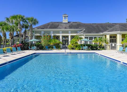 a large swimming pool in front of a house