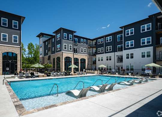 A swimming pool surrounded by apartment buildings.