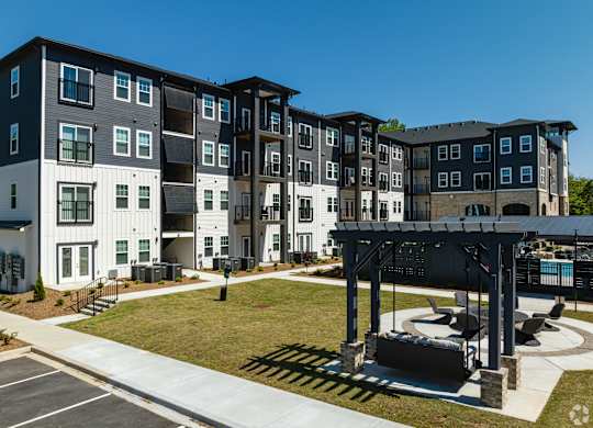 A modern apartment complex with a covered outdoor seating area.