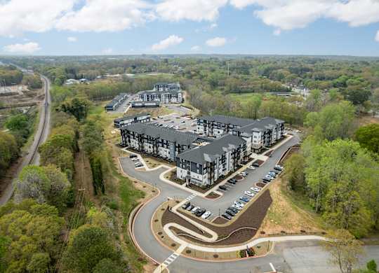 A large building complex with a parking lot in front.
