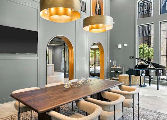 A modern dining room with a wooden table and chairs.