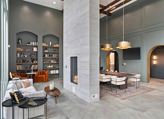 A modern living room with a fireplace and a dining table.