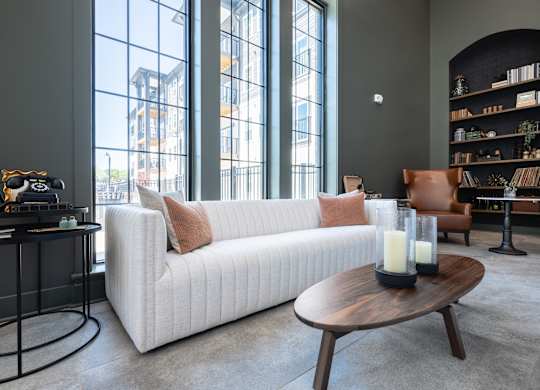 A modern living room with a white sofa and a coffee table.