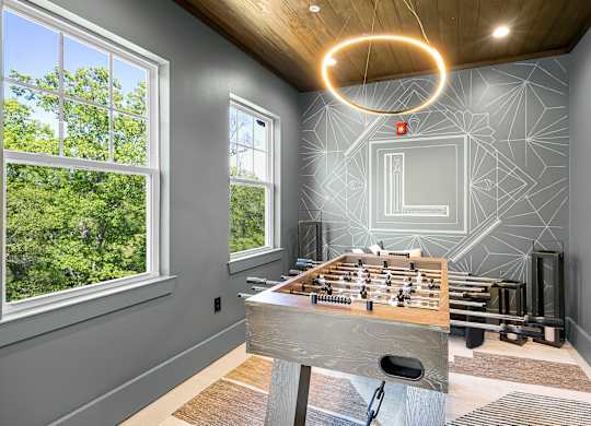 A room with a wooden table and a chessboard on it.