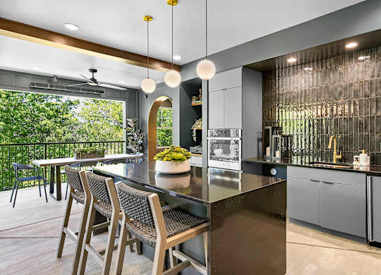 A modern kitchen with a dining table and chairs.