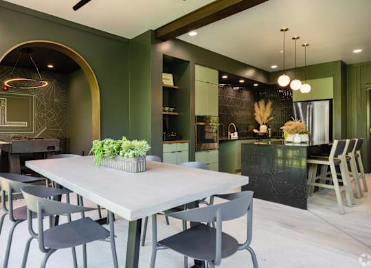 A modern dining room with a table and chairs.