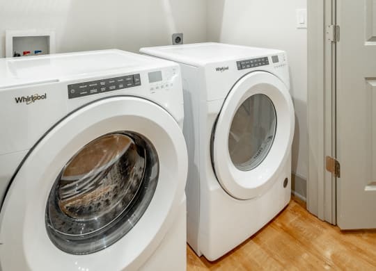 a front load washer and dryer in a laundry room at Anthem Apartments and Cottages in Huntsville, Alabama