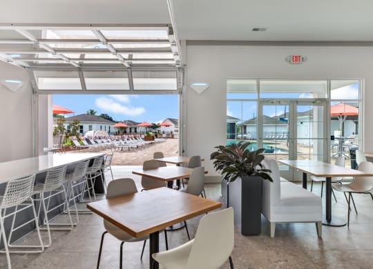 indoor/outdoor social club with kitchen and lounge at Anthem Apartments and Cottages in Huntsville, Alabama