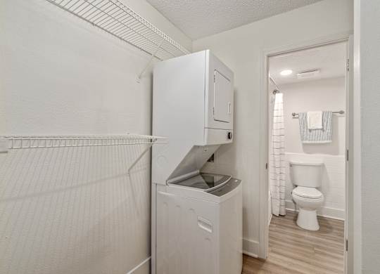 A white laundry room with a washer and dryer.