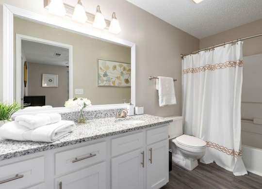 En-suite full-bath with granite counters, white cabinets and vanity lighting at Summerchase at Riverchase in Hoover, Alabama