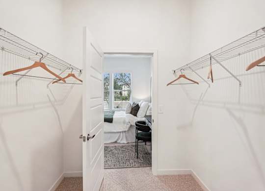 A large bedroom with spacious walk in closet at Tapestry University Park apartments in Sarasota, FL