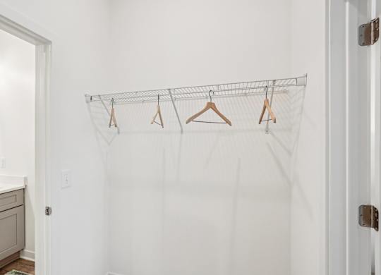 A walk-through closet between a bedroom and bathroom at Tapestry University Park apartments in Sarasota, FL