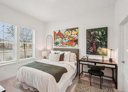 Bedroom with large windows and an en-suite bathroom at Tapestry University Park in Sarasota, FL