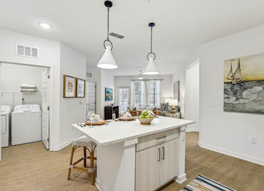 A kitchen with a white counter and a painting on the wall.