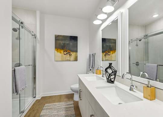 A bathroom with a white sink and a large mirror.