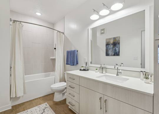 A white bathroom with a toilet, sink, and bathtub.