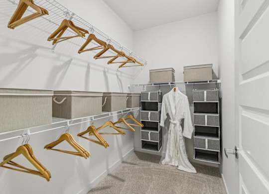 A row of wooden hangers are on a clothes rail.