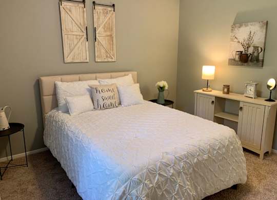 A spacious bedroom with carpet at The Avery at Auburn Apartments in Auburn, AL