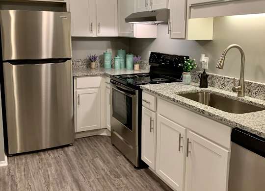 A kitchen with a stainless steel appliances at The Avery at Auburn Apartments in Auburn, AL