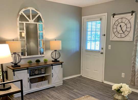 Living room with wood designed flooring at The Avery at Auburn Apartments in Auburn, AL