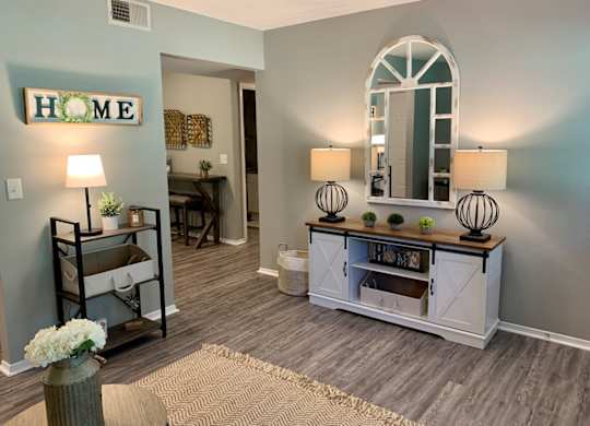 A living room with wood designed flooring at The Avery at Auburn Apartments in Auburn, AL