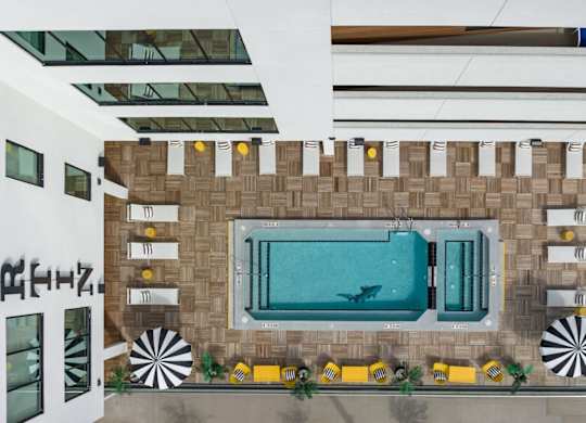 the lobby of a hotel with a pool and a window